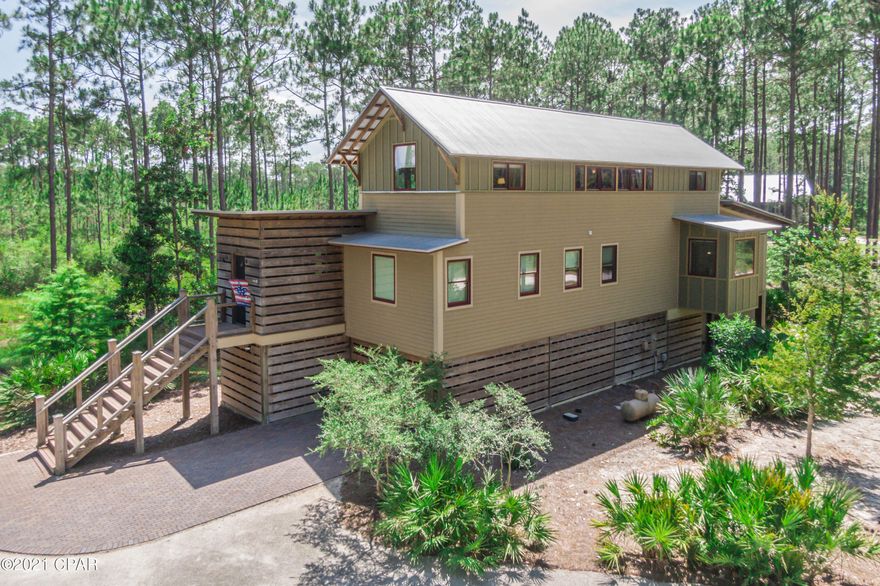 UNDER CONTRACT- TAKING BACKUPS - Straight out of a magazine! We're not kidding; this house is based on a Southern Living Home, and it is picture-perfect and more! Not one thing wasn't thought of in the design and construction of this perfectly located home. With the famous Florida woods surrounding, a private boat slip right on the bay, a massive bayside pool, pickle-ball court, fitness center, and family areas, you never have to leave! The benefits of living here are endless. This is the lifestyle you've always dreamed of, so why not live it!



With hand scraped aged bourbon wood throughout the home. This house is strategically positioned for seclusion and serenity from neighboring lots. No one can build behind this house and views of other properties are dismal. The plants on property are native to the land, and are per the specs of Rivercamps. The driveway is long with space for many additional cars to park and paved with crushed stone. 

One of the many additions to the home was a "Buzz Off" system. This is around the entire property. The system ensures that you won't be hindered by any flying critters with minimal failure percentage. Another addition is a 50 AMP dedicated circuit for spa to be added on if new owner chose to do so. 

On the ground level of the house there is a half bath that is polished concrete and spare room that can be used as a bedroom or hobby room. This house is the only house in Rivercamps to have a bathroom on the ground floor as the codes changed after they built it. 

As far as the footprint of the home, it has been built to Miami-Dade Building Specifications with an upgraded metal rood and with 2x2 concrete footings and extra long pilings and tons of extra concrete this house is sturdy and strong for any storm. Every exterior load bearing wall are 2x6 instead of the normal 2x4 and covered with plywood and vapor barrier paper. All seams are taped including around each window and door, therefor no hollow spots in any walls. All windows and doors are Jeldwen hurricane rated with secure locking mechanisms on the handle and top of doors. All Trex decking joists are on 12 inch centers and stainless steel screws were used to prevent rusting. 

The mudroom on the second floor main entrance has a custom made Kohler Fish Cleaning Sink with storage underneath for coolers and a hook up for an ice maker. 

The first and second floor is wired for speakers for all your entertainment needs or while relaxing in the hammock. 

Laundry room is plumbed for a sink. This room also holds the Rinnai Tankless Water Heater for green usage, money savings and space.