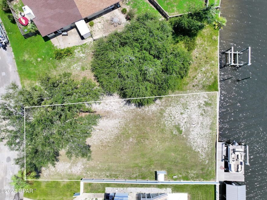SELLER FINANCING AVALABLE with acceptable terms, down payment and credit.

Imagine coming home to a serene cul-de-sac, where your waterfront dreams come true. With 50 feet of prime water frontage and a solid seawall, this property is perfectly equipped to handle your coastal lifestyle. Your private boat dock and lift invite you to explore the rich fishing grounds of Goose Bayou and Saint Andrews Bay. Spend your days casting a line or cruising the waters, with The Hathaway Bridge, Shell Island, and the Gulf of Mexico, just a short ride away.

In the evenings, unwind at Venetian Sunset Park, a tranquil spot just down the road. Here, you can relax in the charming gazebo, watching the sun dip below the horizon, painting the bay in warm hues. The park offers a peaceful retreat where you can enjoy the beauty of nature without straying far from home.

This property isn't just a piece of land—it's the foundation of your future. It comes with engineered plans for a stunning 3-story home, allowing you to start building right away. And when you need a break from the tranquility, you're only 3 miles from the conveniences of city life, with Walmart, Publix, shopping, and dining all within easy reach.

This lot offers the perfect blend of coastal living and modern convenience, providing an unparalleled opportunity to create your dream home. Whether you're an avid angler, a boating enthusiast, or someone who simply appreciates the beauty of waterfront living, this property promises a lifestyle of relaxation, adventure, and endless possibilities. Don't miss the chance to claim your own piece of paradise, where every day is a celebration of the Gulf Coast's natural beauty.

*Boat Does not convey Tyndall Air Force Base: Located approximately 16 miles from 1323 Calabria Road, providing convenient access for military personnel, Bay Medical Sacred Heart: Just 6.5 miles away, making it ideal for healthcare workers looking for housing near Bay County hospitals, Bay District Schools: Multiple schools within 5 to 10 miles, perfect for families and education professionals, Gulf Coast State College: Situated 6 miles from 1323 Calabria, offering a short commute for college staff and students, Eastern Shipbuilding Group: Only 9 miles away, making it a great option for those working in shipbuilding and manufacturing, Trane Technologies: Roughly 5 miles away, providing easy access for employees in manufacturing roles, Naval Support Activity Panama City: Located 12 miles from the property, ideal for those working in naval operations, Bay County Government Center: Just 5 miles from 1323 Calabria, offering close proximity for government employees, Port Panama City: 7 miles away, providing a short commute for those working in logistics and port operations, HCA Florida Gulf Coast Hospital: About 3.5 miles from the home, making it convenient for hospital employees. St. Andrews State Park: Located approximately 12 miles from 1323 Calabria Road, offering easy access to beaches, hiking, and nature, Panama City Beach: Just 11 miles away, perfect for those seeking a quick drive to white sand beaches and water activities, Pier Park: Situated 16 miles from 1323 Calabria, providing convenient access to shopping, dining, and entertainment, Historic Downtown Panama City Harrison Ave: Only 4 miles away, offering a short commute for those enjoying the local shops, restaurants, and art galleries, Russell-Fields Pier: About 16 miles away, making it easy to reach for fishing and sightseeing on the Gulf of Mexico, Shopping and Dining in Lynn Haven: Located 4 miles away, providing convenient access to popular retail stores and restaurants, Downtown Historic St. Andrews: Just 5 miles from 1323 Calabria, known for its charming shops, dining, and waterfront views, Northwest Florida Beaches International Airport: About 20 miles away, offering convenient air travel options for residents, M.B. Miller County Pier: Located 13 miles away, providing a popular spot for fishing and beachside relaxation, Bay Point Golf Club: About 13 miles from the property, offering one of the best golf courses in the area, Signal Hill Golf Course: Located 11 miles away, a scenic and popular choice for golfers, St. Andrews Marina: Just 6 miles away, perfect for those who enjoy boating and water activities, Panama City Marina: About 6 miles away, a hub for local boating and scenic views of St. Andrews Bay, North Bay Haven Charter Academy: Approximately 6.5 miles away, a highly regarded charter school in the area, Publix Super Market at 23rd St Plaza: Located 3.5 miles away, offering quick and easy access to groceries, Walmart Supercenter: Just 3.5 miles away, providing a convenient option for everyday shopping, Schooners: 12 miles away, offering a laid-back beachfront dining and entertainment experience.