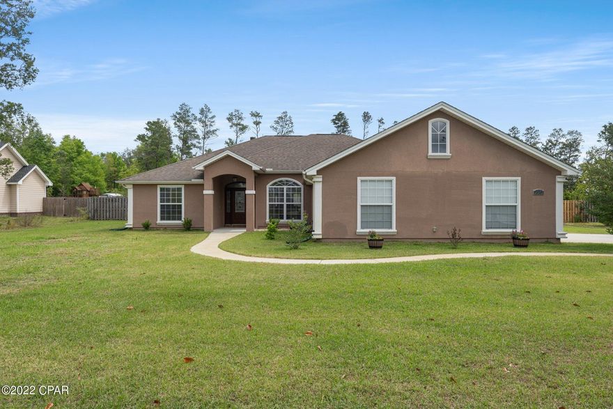 CURRENTLY UNDER CONTRACT, SELLER ACCEPTING BACKUP OFFERS*** Welcome home to Mill Creek!  This property located in northern Bay County is about 7 miles to town, 30 min to the beach, and about 15 minutes to the springs on Econfina Creek!  Flooring  throughout main living areas is wood like ceramic tile with carpet in the bedrooms. Master bedroom features a walk-through Australian closet with access from either side.  Living room floor has installed floor outlets for easy lamp placement.  Stainless steel appliances with a double oven adorn the kitchen along with under cabinet lighting.  Backing in the fireplace as well as the chimney cap are new.  New blinds on most of the windows and a new back door has been ordered and will be installed soon. Home has been prewired for surround sound both indoor and outdoor.  Excellent entertaining area outside with fire pit and hot tub.  Yard is right at 1 acre and goes beyond the privacy fence.  Plenty of room to add a pool!  Sellers are also offering a 1 year Home Warranty!  If measurements deemed important, please verify.