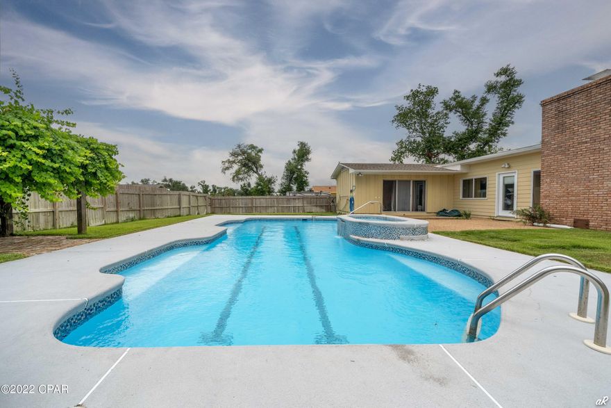 UNDER CONTRACT WITH CONTINGENCIES; SELLER ACCEPTING BACKUP OFFERS.

This four bedroom (with potential for a 5th bedroom) / two bathroom 2450 square foot home with a pool and spa is meticulously maintained with an abundance of upgrades including tiled granite countertops, custom cabinets, stainless steel appliances including Wi-fi enabled refrigerator, and Wolf double oven with 6 burners and a griddle.  There is room for an ice maker.  The oak floors in this home are all original and are well cared for (they look brand new).  A very unique feature of this home is a banquette area right off the kitchen that overlooks the pool and has under-the-seat storage. The sunken den with an exposed beam ceiling is located right off the kitchen and boasts 255 square feet and an ivory white fireplace that is the centerpiece of the room. 
Upgraded lighting and ceiling fans are located throughout the home.
The master bedroom is gigantic, 23.5 feet x 15 feet, and has sliding glass doors right off the pool deck, with a very large walk-in his/hers closet.  The yard is 1/4+/- acre, and the pool is the largest you can build in the Cove and has two lap lanes with a seating area, and separate spa.
This home flows seamlessly from room to room and is perfect for entertaining.  From the custom front door, you enter a spacious foyer that opens right into the living room and from the living room you step right down into the den.  There is a laundry room which opens onto a patio for parking one vehicle and a large driveway where you can park multiple vehicles.  Off the den, there is a large room which could be utilized as an office or bedroom (if you were to put in a pocket door or french doors).  The bedroom layout is perfect for privacy as the three guest bedrooms are on one side of the home, and the master bedroom is in the back of the home.  
Each bedroom has an oversized closet that is perfect for additional storage.  Another prominent feature of this home is the state of the art kitchen with pantry and private beverage closet, and plumbed space for an under-the-counter ice maker.
This home is by far one of the most beautiful, spacious, and meticulously maintained homes in Cove Terrace.  Other features of this home include:  meticulous tilework in key areas, two air conditioning systems, foyer with beautiful cottage-style built-in bookcases, double pane windows, gas starter on fireplace, sprinkler system with irrigation meter, a passthrough kitchen, and just a few blocks from an A-rated elementary school.
Cove Terrace is located just a few blocks from the marina for fishing and Shell Island excursions.  Cove Terrace is known for a relaxed, family friendly atmosphere where bikers, joggers, and strollers enjoy the beautiful Florida outdoors. 
Finally, the Cove area is located close to the Civic Center, Tyndall Air Force Base, Sacred Heart Hospital, Highway 77 shopping and restaurants, and easy access to both Panama City, and Lynn Haven.  The Cove area has all the amenities and half the taxes.  Schedule your private viewing of this home and prepare to be amazed.