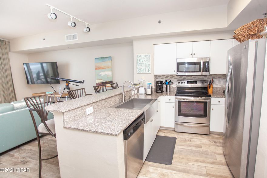 This one won't last long!  This true gulf front condo at Shores of Panama is exactly what you've been looking for in a condo.  The condo has wood grain tile throughout the entire condo.  The kitchen is modernized with stainless steel appliance, back splash, over sized stainless farm sink, and granite counter tops.  The owner just purchased in the last 6 months 2 new smart Tv's, new hot water heater, new front loading washer and dryer, and new king mattress for master bed and mattress for living room sleeper sofa.  The bunk area is already framed up with a door to block it off.  Condo also comes with dedicated parking spot on same floor!  2nd closest parking spot to the condos! This and more!  This condo is perfectly ready for enjoying or renting!  See it before it's gone!