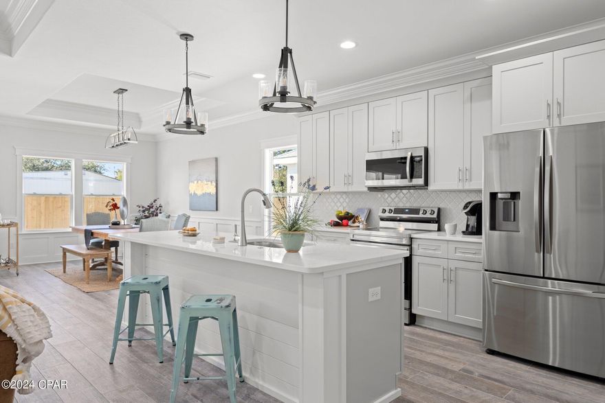 Construction complete. Welcome to Laguna Haven - new secluded gated community located at the West End of Panama City Beach, north of US-98. This Calabria floor plan features 3 bedrooms, 2 full baths and 2 car garage. Exterior features Cement Hardie Backer Board siding, paved driveway, lush landscaping. Step inside the home to find wood-look porcelain tile, soaring ceilings, crown molding, bull-nose corners give those extra touches of elegance, and a designer lighting package. Your kitchen features Samsung (fingerprint-proof) stainless steel appliances, a walk-in pantry, soft-close Shaker cabinets, an under-mount sink, Calacatta Bravos quartz countertops, and Satory mosaic backsplash. Just steps away, you can enjoy the fully landscaped backyard featuring a built-in sprinkler system with a separate irrigation meter. Back inside, the bathrooms include all of the same high-end finishes found throughout the rest of the home, including shaker-style vanities, designer fixtures and porcelain tiles. The master bedroom boasts tray ceilings & recessed LED lights, while the ensuite has double sinks and a custom-tiled walk-in shower with a glass door. Don't forget about all the storage in the laundry room and attached garage! This home comes with a 1-year builder warranty, and the HOA includes exterior & common area landscaping and trash pick-up, as well as community lights, fountain & gate maintenance. Public water and sewer. Laguna Haven is close to schools and all the shopping, dining & entertainment options along the Panama City Beach Pkwy and 30A. Another BONUS for you in this community that's LESS THAN ONE MILE from the beach: Short-term rentals are allowed! New residents are arriving in Florida every day, so make your appointment now to see this NEW CONSTRUCTION home before someone else does!