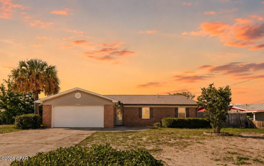 Welcome to 1525 Donna Avenue in Parker, FL--a charming, traditional brick home offering comfort, convenience, and a true taste of coastal living.

Tucked into an established, no-HOA neighborhood, this well-built home carries timeless brick character paired with a warm, inviting feel the moment you arrive. Inside, the layout is comfortable and easy to live in, offering a sense of space that feels familiar and welcoming. A dedicated dining room adds a feature you don't often find in newer builds, creating a natural place for gathering, meals, or work space. The electric fireplace serves as a cozy focal point in cooler months, while still adding subtle charm and character year-round.

One of the standout features is the glimpse of bay views, offering just enough water in the distance to remind you how close you are to the coast--where sunrises, sunsets, warm breezes, and that easygoing coastal rhythm are part of daily life rather than just a weekend escape.

The location is especially convenient, just about 13 minutes from Tyndall Air Force Base, making it ideal for military, civilian, or investment buyers who want quick access to the base while still enjoying a quieter residential setting. The neighborhood also reflects a relaxed, established feel, home to many retired veterans and long-time residents who value its steady, down-to-earth atmosphere.

Just nearby, you'll find Under The Oaks Park, a local favorite featuring a classic playground, walking path, disc golf, picnic areas, and beautiful bay views beneath sweeping, moss-draped trees. For those drawn to the water, Smugglers Cove Marina and Gulf Oaks RV Park make boating, fishing, and waterfront weekends incredibly accessible.

Everyday convenience is close at hand with dining, shopping, and local favorites throughout Callaway and Panama City. The area continues to grow in a thoughtful way, with new coffee shops, restaurants, and grocery options joining long-standing staples. Revitalized downtown Panama City along Harrison Avenue is just a short drive away, offering even more options for dining, shopping, and entertainment. And when you're ready for the coast, the white sand beaches of Panama City Beach are only about 30 minutes away.

This home blends traditional brick durability, a welcoming neighborhood setting, and a location that connects you to both nature and convenience. Whether you're searching for your first home, an investment opportunity, or a place to settle into a steady coastal lifestyle, let this one be your comfortable, inviting place to land with just the right touch of coastal charm.