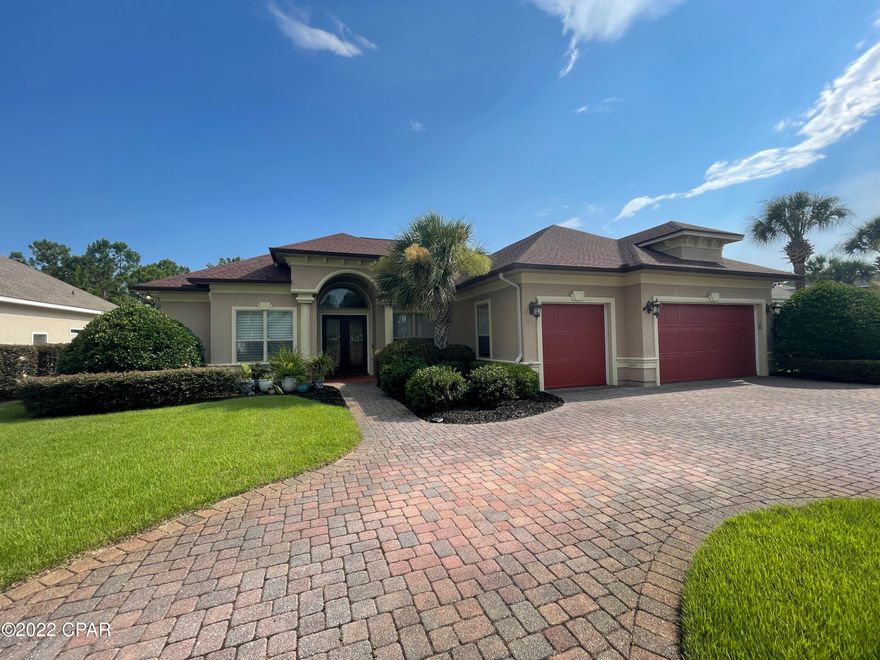 GORGEOUS 4 bedroom, 3.5 bath executive home in the Glades subdivision located in the heart of Panama City Beach! Step into this expansive home with over 3,000 sq ft open concept floor plan and find custom construction touches throughout. The kitchen features stainless Kitchenaid appliances with a breakfast bar island wrapping around the formal living and family room. Formal dining room with gorgeous chandelier leading into a hallway with dream laundry room & 3 car garage door access. The home has a split bedroom plan with a huge master suite with 12' trey ceiling, en suite bathroom with double vanity, jetted tub, walk-in shower, and his/her walk-in closets. There is a guest half bath off the formal living room and an office/exercise equipment room. The other side of the home offers 3 additional bedrooms, one has an en suite bathroom with access to the back patio. Two additional bedrooms with jack-and-jill shared bath. The outdoor space is incredible with privacy backing up to conservation land completely fenced in. Large covered lanai and open patio with hot tub for stargazing after a day at the beach. Golf cart friendly neighborhood with plenty of garage space at this one-of-a-kind rental home. Rent includes professional lawn service and hot tub service. Must see! Call today for an appointment. *Pets negotiable upon approval with non-refundable $350 pet fee.