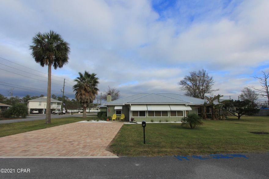 Tastefully updated 4+ bedroom 2 bath home on a double lot in beautiful Mexico Beach. The large windows of the Florida room provide an open/airy feel leading into the living area. Kitchen features a stunning backsplash & granite countertops with island & breakfast bar. The living area has direct access to the large screened & tiled back porch. The master bedroom has an oversized custom closet with vanity & full bath including tile shower & separate tub. Each add'l bedroom is of ample size,1 with direct access to the 2nd screened porch. The guest bath also features a large vanity with tub/shower combo. The 4th bedroom & office space are on the opposite end of the home with direct access to the dbl garage. No shortage of storage with multiple closets, screen rooms & yard bldg. Home is X flood