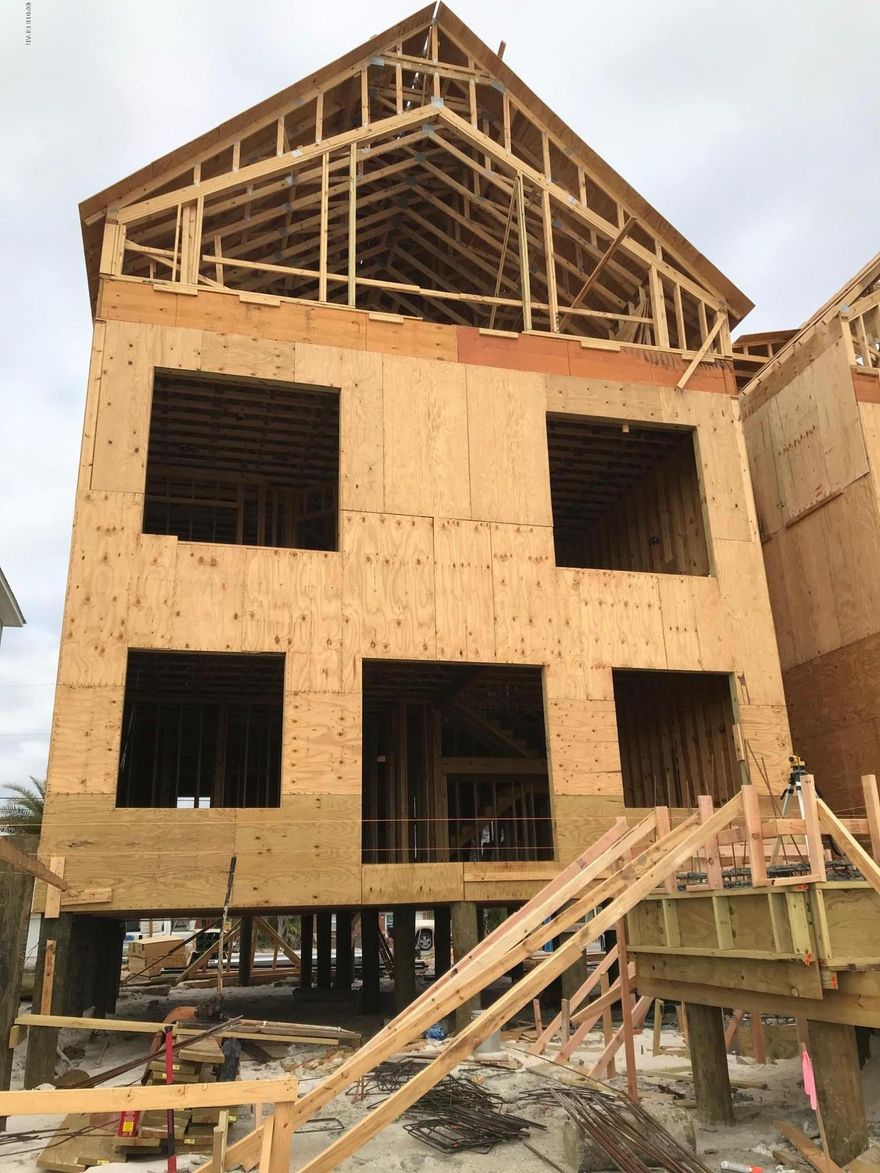 Under Construction, Great new Beach home in a up scale area of Surf Drive  designed to maximize rental income.  Home is 4024 square foot conditioned Air and over 1240 square foot of desks consisting of 775 of covered and 485 square foot of open pool deck right on the Gulf. The pool is L shaped with a lounger area with a fantastic view of the setting sun and beach from the pool or  any of the three decks. Over sized private master suite, large Rec Room, loft and oversize bunk room with two separate dressing areas and 7.5 baths with plenty of room for up to 30 people.  All this right on the Gulf with a 60,000.00 furniture package credit at closing.