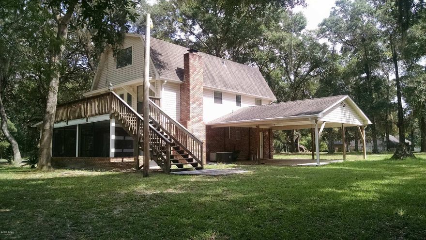 Deer Point Lake canal home. You'll enjoy this remodeled home situated on 1.25 acres with a fishing dock and separate garage and workshop. Property is high and dry and completely fenced. Dock on canal leads directly to Deer Pt Lake. This home offers a contemporary look in a wonderful country setting. Living area with fireplace and large screen porch on first floor and updated kitchen with maple-wood cabinetry and corian counter tops on second level. Directly off kitchen & dining area is a deck overlooking the backyard and canal. Top story offers loft/office and another bedroom. Home has been completely refurbished along with new interior paint. Attached two car carport along with a detached garage and workshop offer plenty of room for all your projects. Call to view this property and home.. Survey available, current WDO bond in place, Vertical blinds also convey.