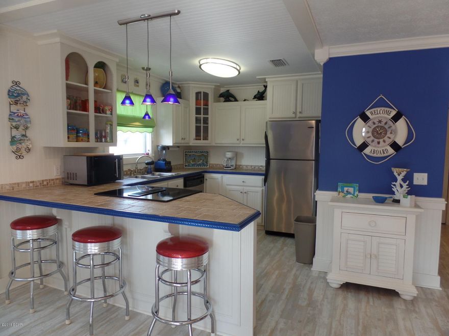 It won't get any better than this! Sold FULLY FURNISHED in coastal decor, this precious updated home is perfect for a second home or for a beach rental. There is a large one car garage AND a carport big enough for boat storage. You will love the enclosed outside shower and the large wrap around porch. This 2 BR, 2 BA home is the perfect size sporting a big backyard. Just a few blocks from the beach, you can walk or ride in minutes! New roof in 2009!  Are you ready to own an awesome beach house? Sign the papers and all we will need is a name for the mailbox!