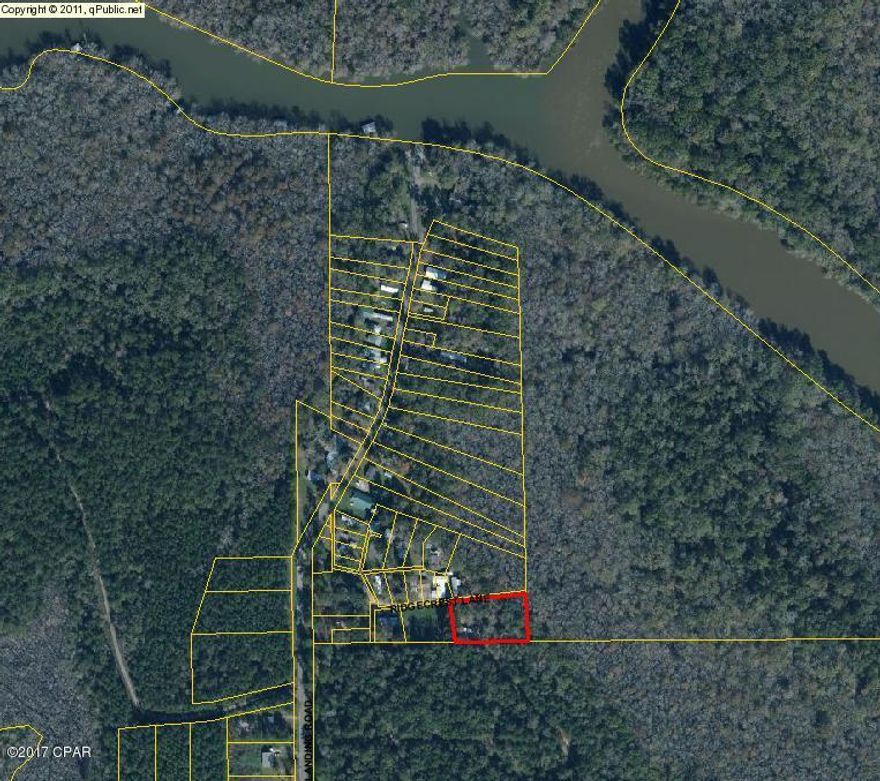 Beautiful cleared lot at Bryant's Landing. Previously had a mobile home on it and was used as a fish camp. Still has concrete porch and steps. Just seconds from the boat launch. Community sewer and water! Pull in your mobile home and start enjoying. 20x16 Covered boat shed and screened in fish cleaning building with sink. Perfect for hunting and fishing the Chipola River. Priced to Sell!!