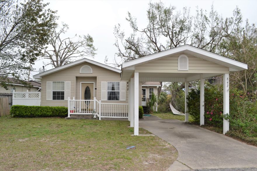 CHARMING HOME in established area! Built in 2001, this home features 2 good size bedrooms, 1 full bath with soaking tub and separate shower, over 1,300SF, a semi-open floorplan, a front sitting room and interior laundry. Off the kitchen is a lovely enclosed porch with an adjoining covered deck, perfect for outdoor entertainment.  The exterior features a detached carport and a storage shed.  There is an alley way behind the home.  Call today for a private preview.