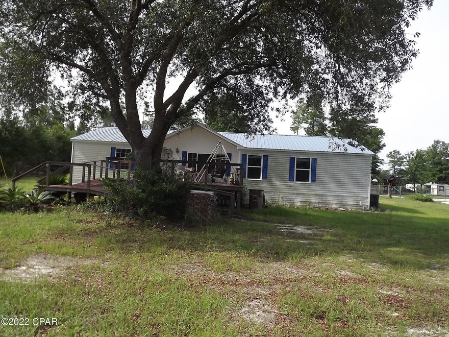 CURRENTLY UNDER CONTRACT, SELLER MAY ACCEPT BACK UP OFFERS,  PRICE REDUCTION, GREAT BUY   This is an AS-IS Sale, you can view it now.  This is a Large Double Wide Plus with extra room and a open floor plan.  This has great possibilities and offers a 1 acre lot for expansion.  It does need some TLC.  A Family can have a place to enjoy the quiet of the Country.  It is Close to Schools and convenient to Lynn Haven, Panama City the Airport and the Beaches. Take a look and make this your country getaway or full time home. Additional Photos coming soon.