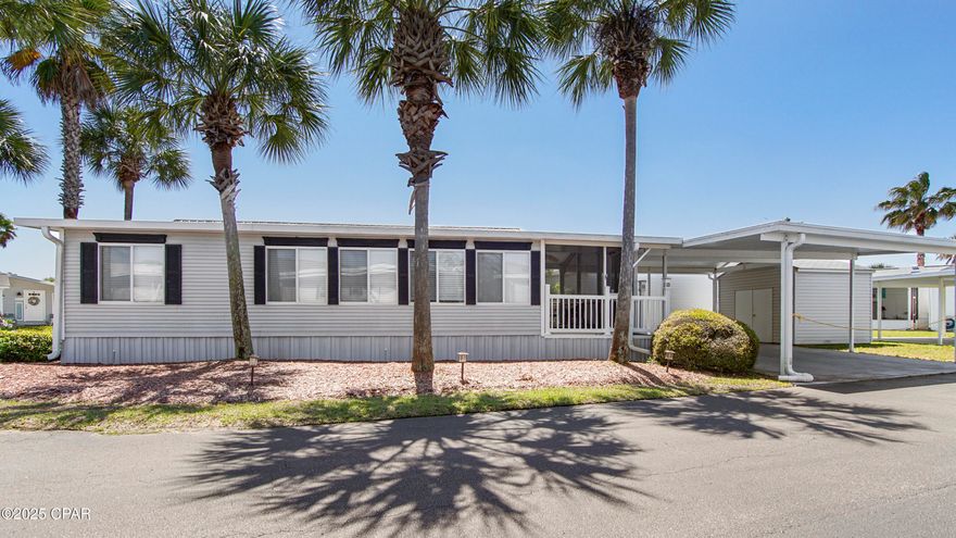 Tucked away on the largest lot in the sought-after Emerald Pointe community, Seven Palms is a beautifully maintained 2-bedroom, 1-bath mobile home that lives up to its name—surrounded by seven stunning, manicured palm trees. Located on a quiet corner lot in one of the cleanest and friendliest golf cart communities in Panama City Beach, this fully furnished home offers both comfort and convenience in a resort-style setting.

It's ideal as a full-time residence or a vacation rental. Enjoy your morning coffee on the screened porch, park under two covered carports, and take advantage of the outdoor storage space with a washer, dryer, and extra room for beach gear or tools.

Emerald Pointe residents enjoy a laid-back, social lifestyle with access to heated swimming pools, hot tub, a fitness center, and a clubhouse with a ping pong table, cozy library, and plenty of space for community events. Outdoor shuffleboard courts and a peaceful community pond add to the charm. Plus, lawn care and palm tree trimming are included, so you can spend more time relaxing and less time worrying about maintenance.

The community is known for its friendly vibe—neighbors gather for BBQs, celebrate holidays together, and cruise around on golf carts. You're just minutes from the beach, local dining, and all that Panama City Beach has to offer.