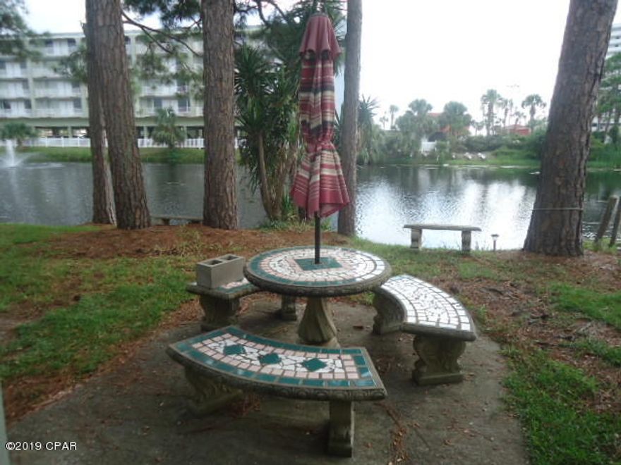 ENJOY owning a nicely appointed 2 bedroom - 2.5 bath town home in a great location, close to the beach walk and with a patio overlooking the lagoon!  A new roof was installed in the summer of 2018. The entire downstairs flooring is ceramic tile.  There are two bedrooms upstairs.  One of the bedrooms has both bunk beds and a queen size bed.  The upstairs flooring is vinyl wood.  There is a porch off of the master bedroom overlooking the lagoon.   There are two reserved parking spaces right at your front door.  And, one of the best values in Home Owners Association dues on the beach at only $450.00 per QUARTER!  Age, SF, and dimensions are approximate and should be verified if important. The Gulf Highlands Beach Resort has a gated community, a club house and pool on the Gulf, 10 other pools 5 heated, lighted tennis court, shuffleboard and putt-putt course, exercise facilities, community center ... all this located within a short distance to entertainment, dining and shopping. Age, square footage and dimensions are approximates and should be verified by the buyer if important!