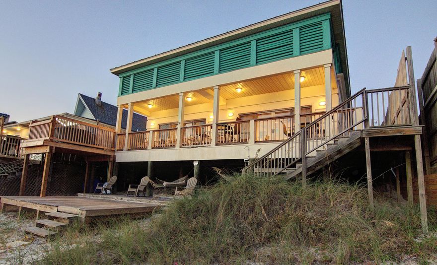 FANTASTIC RENTAL! Over 150 nights already booked this year. This 5 bedroom, 3 bath home sleeps 22 and comes fully furnished and rental ready. Great rental property or even a second home. Spend the day on the beach then take a dip in your own PRIVATE POOL and HOT TUB just steps away. Covered deck for watching the sunset and large uncovered sun deck for catching rays. Interior features include tile and hardwood floors, large kitchen with custom cabinets, tile backsplash and breakfast bar, stained wood trim throughout. Master bath features a jacuzzi tub and separate tiled shower. Located on the east end of Panama City Beach close to Schooners and the State Park. Measurements taken from proper appraisers office. Buyer may verify if important. Don't miss your chance to own this DREAM BEACH HOME