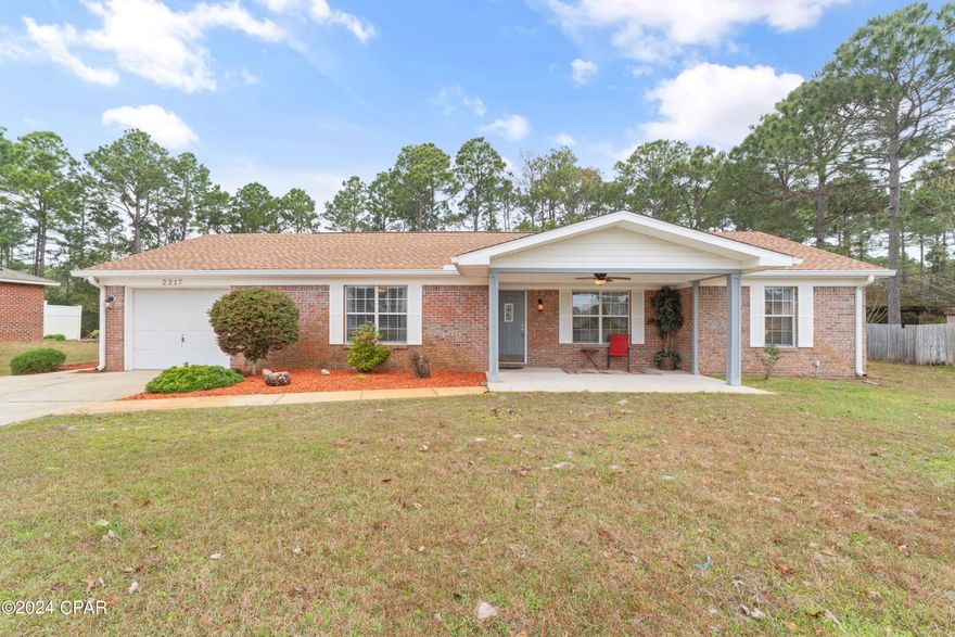 In the heart of Holley Navarre's serene neighborhood, this all-brick residence wrapped in vinyl trim stands as a beacon of low-maintenance living. A spacious double-wide driveway welcomes you, leading to a home nestled amidst a sprawling front yard, creating an inviting retreat from the hustle and bustle. Inside, this three-bedroom, two-bathroom sanctuary is designed with comfort in mind, featuring a convenient utility room off the kitchen for seamless living. Just two miles from the beach, the allure of the gulf is never far away. Perfectly positioned for families, with easy access to top-rated schools, Publix, Starbucks, and breathtaking Navarre Beach, convenience is just a part of life here. Recent enhancements including a new roof in 2023, a modern HVAC system, an efficient water heater, luxurious porcelain flooring, and shiny new appliances ensure this home is not only beautiful, but also brimming with upgrades. The expansive screened porch and vast backyard offer private oases for relaxation or entertaining, in a home that exudes cleanliness and meticulous maintenance. This is more than a house; it's a lifestyle waiting to be embraced.