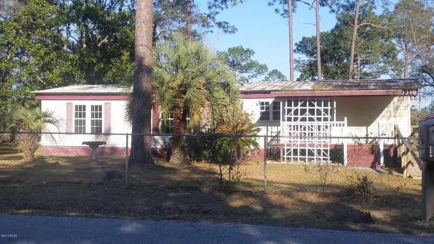 Super clean double wide located centrally to everything in Bay County.  This home sits on a large 150x130 lot in Lynn Haven close to Transmitter, 390 and 231.  Enjoy a country feel with the benefits of living in town.  The possibilities are endless for this great property.  For ease of maintenance there is a metal roof and vinyl siding on the outside.  All appliances convey making this an easy move in.  Out back in the fenced in yard there are mutliple storage sheds and the back of the home has a Florida room for even more livng space. Don't hesitate on this one!  Call your Realtor today.