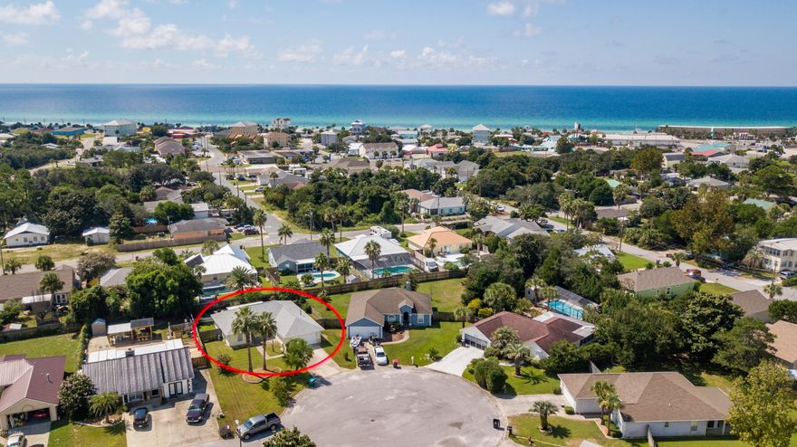 This Beach house is only .3 miles to the Worlds Most beautiful beaches. Take a stroll or jump in your golf cart and you will quickly have your toes in the sand. GREAT location!!! Only a 5 minute drive to Pier Park to enjoy all the restaurants and shopping. NEW ROOF, NEW WATER HEATER, NEW WELL PUMP, NEW GARAGE DOOR OPENER and NEWER HVAC (only 2years old)!! Move in ready -- this lovely 3 bedroom 2 bath home features an open floor plan with split bedrooms. It is located in a cul de sac and has a spacious backyard with a privacy fence and a large screened in & tiled porch with gas grill. Mature fruit trees in the backyard include LIME, ORANGE, 2 FIG Trees and a GRAPEFRUIT Tree!! Also a fire pit in back yard to enjoy!! The flooring is laminate except the bedrooms which are carpet. Master bedroom has a huge walk-in closet, the laundry room is located right off the kitchen and the kitchen has a decorative backsplash ana breakfast bar. Come view this great home today!!