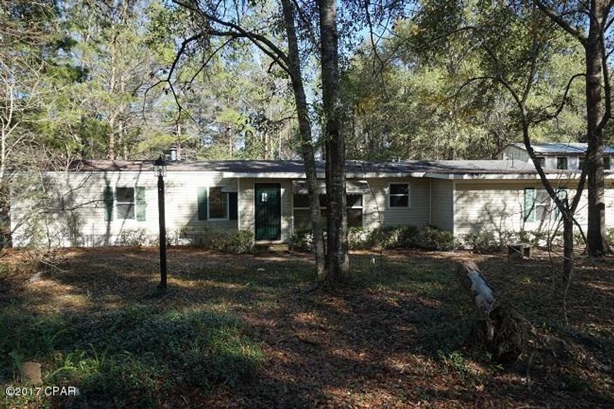 Split floor plan on this 2 br home on a paved road, short distance from the lake, attached carport, detached carport/workshop, over an acre with an enclosed front porch, rear screened porch, play house for the kids and more.  Needing some updates but this could be a great weekend retreat with great proximity to several lakes.  Don't wait on this one.