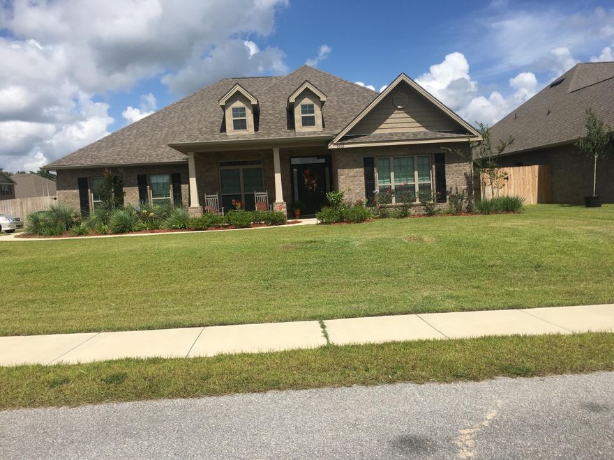 Upon entering the foyer you will realize that this home is like no other. The wide foyer with double arches setting off the dining room is very elegant. This home was designed with entertaining in mind. The family room and kitchen are open to each other with a long wrap around bar dividing the space. You will love preparing family meals in the kitchen that features granite counter tops, a large island, and designer cabinets. The master suite is huge with everything you are looking for: garden tub, separate tiled shower, linen closet, and walk in closet, water closet, trey ceiling and an entry way onto the back porch. On both sides of the house you will find double bedrooms and adjoining baths for the four secondary bedrooms.