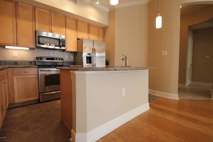 Ground Floor Unit! If you haven’t been to Island Reserve recently then you are missing out on something great. Life at Island Reserve is similar to what you might expect from a 5 star resort. Island reserve is an oasis away from all the hustle and bustle of Panama City Beach, but in a prime location: just a little over a mile away from both the World’s Most Beautiful Beaches and the Hathaway Bridge. Island Reserve features low association dues and unbeatable amenities including the largest pool in the Bay County area (1 acre) w/ two waterfalls, a Splash Pad for the kids, numerous seating arrangements for your poolside entertaining, a heated and cooled indoor basketball court, fully stocked state of the art fitness room a game room, a theater with 105 inch screen, gated community with security day and night. Plus, no short term rentals are allowed in Island Reserve so that means no Spring Break traffic at all! Mainly full time owners and residents throughout the entire complex. This is truly turning into one of the premiere residences in all of Bay County with a very well run association and friendly maintenance staff. The unit has 2 Master Suites and each bedroom has a door to the large private patio. The rich Bamboo Floors and Granite Countertops throughout along with Stainless appliances make this luxury condominium hard to resist. There are elevators and stairs in each building. Covered Garage parking so you don't ever get wet coming in from the rain. Resort Living close to everything in Panama City Beach. Beach is 1.4 miles away or 3 minute drive from Island Reserve.