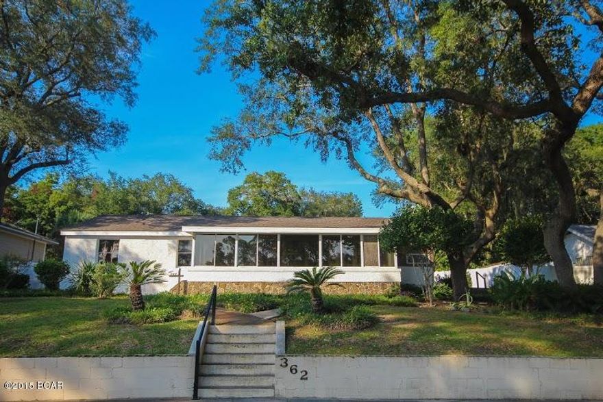 Spacious waterfront home on Massalina Bayou with endless opportunities. This unique home was built in 1945 and includes a 2 bedroom, 1 bath apartment that was built in 1954 located over the detached 2 car garage.  Seller said the main house at one time used to be 2 individual apartments and has since been opened up as one house.  Main home features 2 bedrooms, 2 bathrooms, hardwood floors, lots of  windows to enjoy the amazing views of the Bayou,  several  rooms throughout that can be used for various things such as office, sitting room, children's playroom or hobby room. Grab a cup of coffee and relax in the large Florida room while  watching the sun set. Apartment  features living room, kitchen, 2 window a/c units and hardwood floors. This would make a great rental or place for your guest to stay.  A new A/C with metal duct work was installed in 2010 in main home, new roof on house and apt in 2012, North Austin fence installed in 2012, 4 Anderson storm doors installed in 2012, 6 new ceiling fans,  11 new windows installed, updated electrical, 2 new garage doors, French drain under patio that goes to front yard  and transferrable Termite Bond in place.  Main house has central A/C and both house and apt have gas heat, hot water heater and stove. Luscious landscaping with large oaks. Dock and boat lift with deep water access  to Bay. Dock has plumbing and electrical in place.