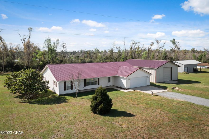 Under Contract, seller taking back up offers....This home is a great place to enjoy the peace and quiet of country living, but enjoy the convenience of being less than 20 minutes from Marianna.  This spacious three bedroom, two bathroom home has so much to offer including a two car garage and a metal roof.  Primary suite has two large walk in closets.  The property has a a 30x48 workshop with a concrete floor and electricity.