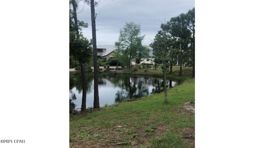 Motivated sellers... OFFERS WELCOMED.  Water view lot in the gated community of Martinique. Neighborhood features Old Florida Architecture style homes in a GREAT location. Hiking distance to Captain Anderson's, Grand Marlin, and Lighthouse Marina. Community pool, hiking trails, and LOW HOA's. New survey completed in February 2021 (less than 4 months old) and this property is one of the few located in FLOODZONE X (no flood insurance required!). Also have buildable house plans available.