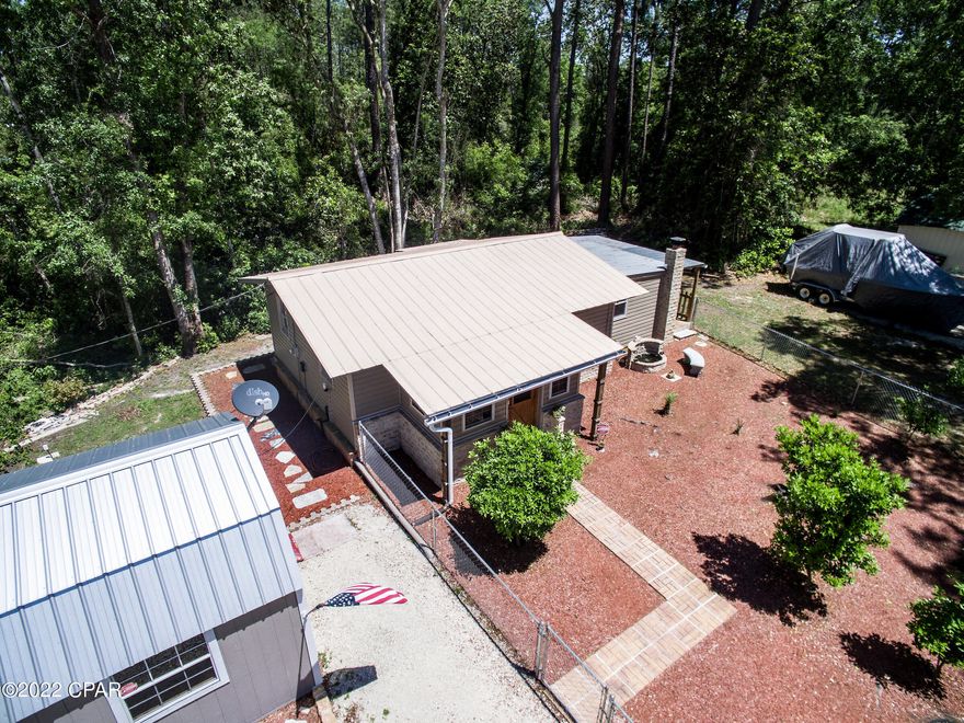 Great opportunity to own for less than $200,000. This  house is located on the north side of Highway 388  about two miles from the airport.  This would be great for a permanent residence or as a weekend fishing get a way. IT IS ONLY TWO MILES FROM THE PUBLIC BOAT RAMP ON BENT MILL CREEK ROAD. The current owners have done a lot of work on house. There is tile in the kitchen and other areas of the house. The family room could also be used as another sleeping area if desired.  It has a nice enclosed front porch as well as a side outside covered porch. There are two large nice outside buildings. One is 18x20 and has very nice stone  flooring. The other building  is 12x24 with a roll up door.  There is a septic hook up for an RV in the large parking area. Plenty of room to park a large boat. The kitchen has stone counter tops. Stone is  partially up the wall
in the den. The bathroom has stone counter top and tile shower as well as a tub. The well is a deep water well.