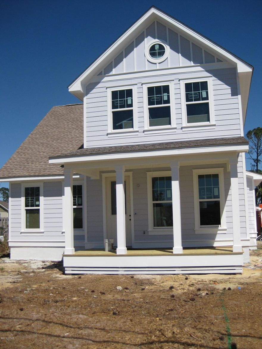 Currently under contract, seller taking backup offers. Purchase now and have input on floor covering and colors! This new home is close to the navy base, schools, restaurants and all the Panama City Beach attractions.  It is unique in that it faces North Lagoon and Poinciana Dr, both of which are paved. You can enter the garage from the rear of the home and park in the front of the house . Looking to stay in shape? There is a county maintained walking/jogging path on the front side of the home. The home features 9' ceilings, 2 large covered porches, 2 Central A/C units for better comfort and savings,  and a jetted bathtub in the master bathroom.  Ample storage space.  Measurements approximate. Verify if important. Listing agent has equitable interest in property