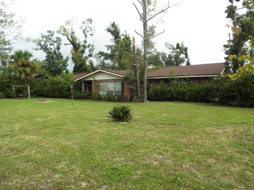 Reduced !!!  Three bedroom two and half bathroom brick house on .34 acre lot within walking distance of Lynn haven Leslie Porter Wayside Park. This home needs some updating and repairs but features two 2 car garage a  large Florida room and large back yard All sizes are approximate or taken from other sources please verify accordingly.