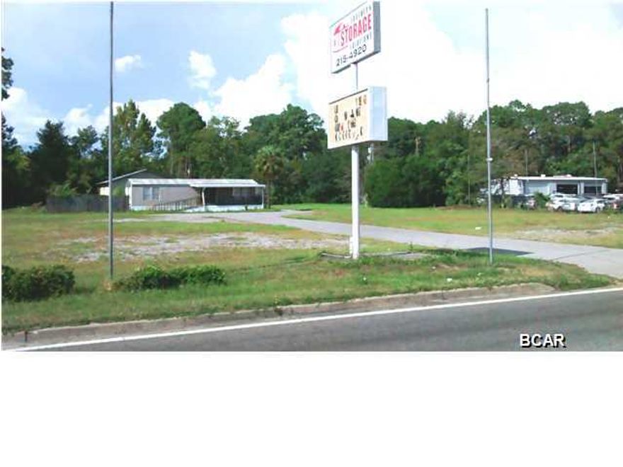 **Prime Commercial Location on one of the busiest streets in Bay County.** High visibility and high traffic counts. This is a perfect location for a car lot, mobile home dealership, portable building dealership, automotive repair, etc. The property is 1.37 acres, with 214' of road frontage. It's located on HWY 98/15th St. between Sherman and East Av. and is situated between the Dollar General store and KIA dealership. On the property there is a singlewide office building, consisting of 2 offices, a lobby area, and a bathroom. Behind the office is a 30x50 cinder block warehouse, with a large roll-up door.