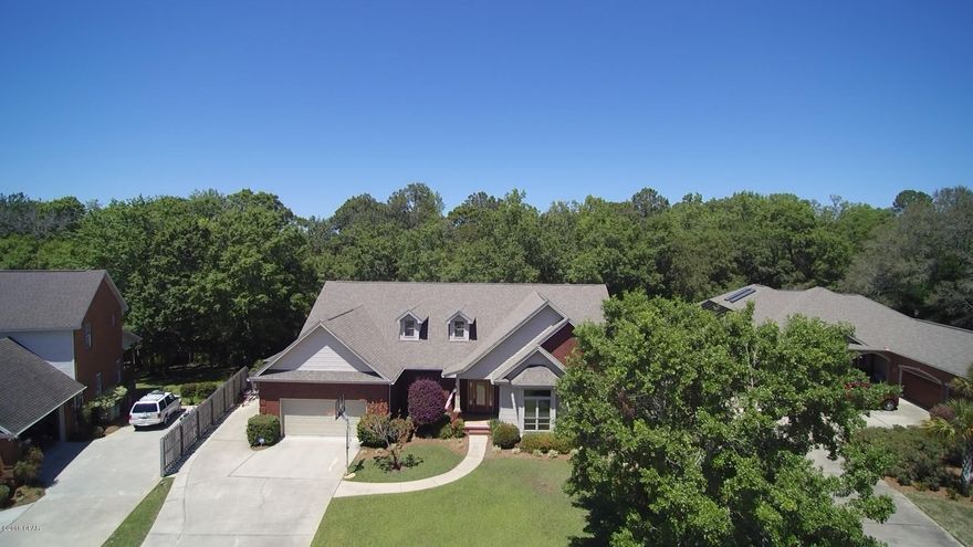 Spectacular custom built all brick home in prestigious neighborhood. This luxury home features all the upgrades you've always dreamed of. You'll appreciate the craftsmanship & functionality this floorplan provides. Open spaces, high ceilings, real hardwood floors, crown molding & tiled baths accent throughout. Kitchen is well appointed with granite counter tops, large pantry & an abundance of cabinet/storage space. Open living room features gas fireplace. The spacious master includes crown molding, tray ceiling, and a luxurious bath. An oversized lot on McCain Creek offers the ultimate in privacy for your backyard extravaganza, along with a heated (gas/solar) lap pool & hot tub complete with automatic cover. Home also has an office, separate third car garage/workshop, security system, is wired for surround sound, offer a WDO bond and survey.