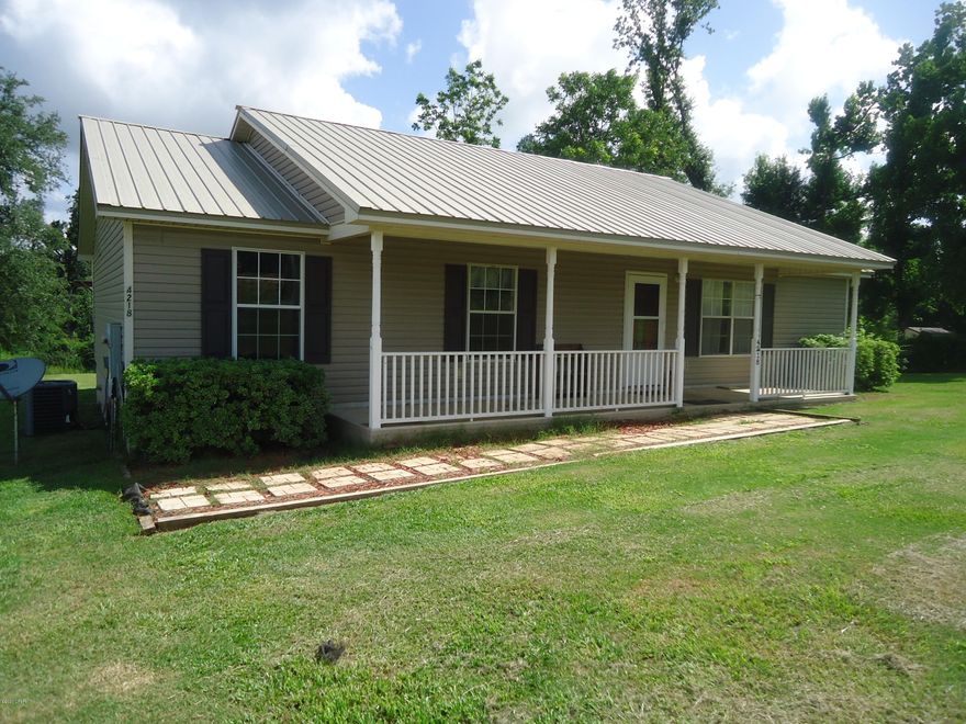Open Living home with 3 bedroom and 2 bathrooms on a little over an acre In the Marianna City limits. There is a large covered back porch that is great for spending your mornings on and grilling your evening meals.  The back yard has plenty of  room for a garden space and plenty of room for children to play.