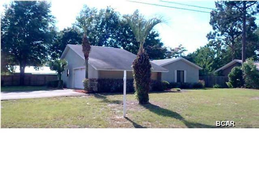 This charming ''move in ready'' home is perfectly located in a beautifully kept family neighborhood. This home is NOT in a flood zone and is on a large corner lot. As you enter the front door you are welcomed thru a foyer to a large living room featuring vaulted ceiling, a beautiful wood burning fireplace on the west wall and a full height mirrored wall on the east side. As you continue into the kitchen you find a U shaped area with a separate dining room to the right and an ample laundry to the left with direct access to the oversized garage. The entire east side of the garage has a full length storage work area. Inside you will appreciate the clean, neat and well cared for condition. Quality Berber carpet can be found throughout the home. The master bedroom is large with two closets,