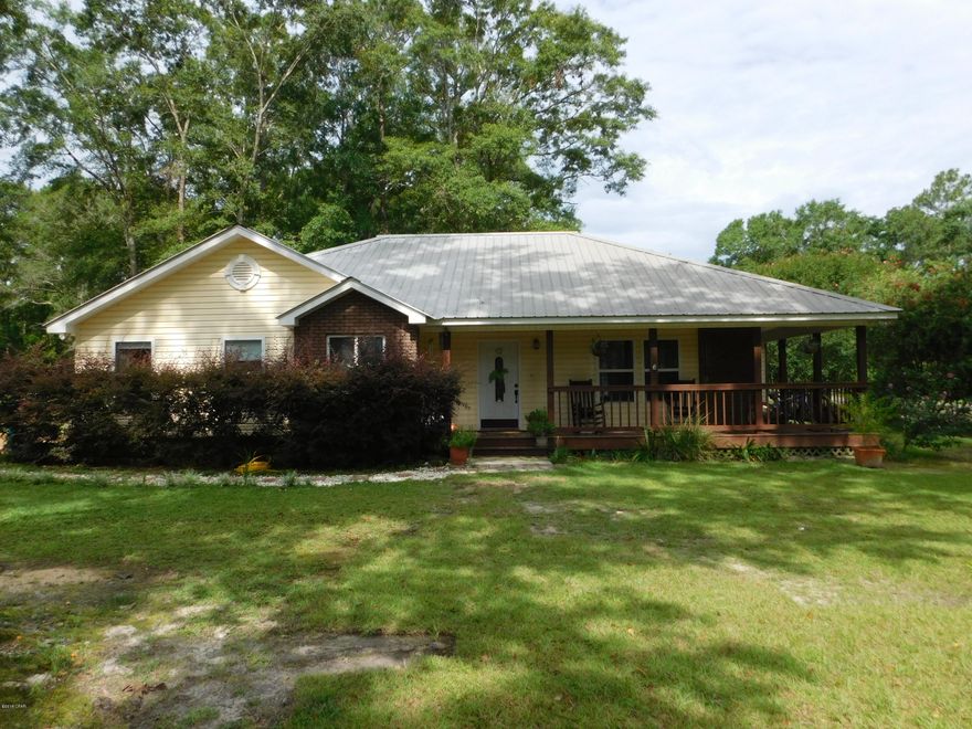 Nice country setting with this 3/2 home. Home offers a spacious kitchen with lots of storage and pantry, dining area with french doors leading to the screened in porch, living room with recessed lighting, master bedroom with walk in closet, master bath has garden tub and separate shower. There are 2 additional bedrooms and guest bath. Wrap porch. Metal roof. Fenced in back yard. Nicely landscaped 1 acre corner lot. Not far from Falling Waters State Park, shopping, medical facility. This is a must see!