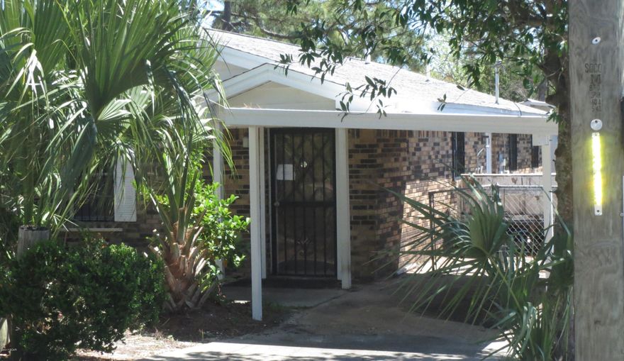 GREAT LOCATION is all you need to say about this beach house!  Within walking distance to the Gulf of Mexico, this home has an open floor plan with a combined  kitchen, dining and living area.  The Master bedroom has a Master bath and there is a full-size guest bath, as well.  Outside is a covered carport and additional workshop or storage building.  The home is being sold in its AS IS condition.