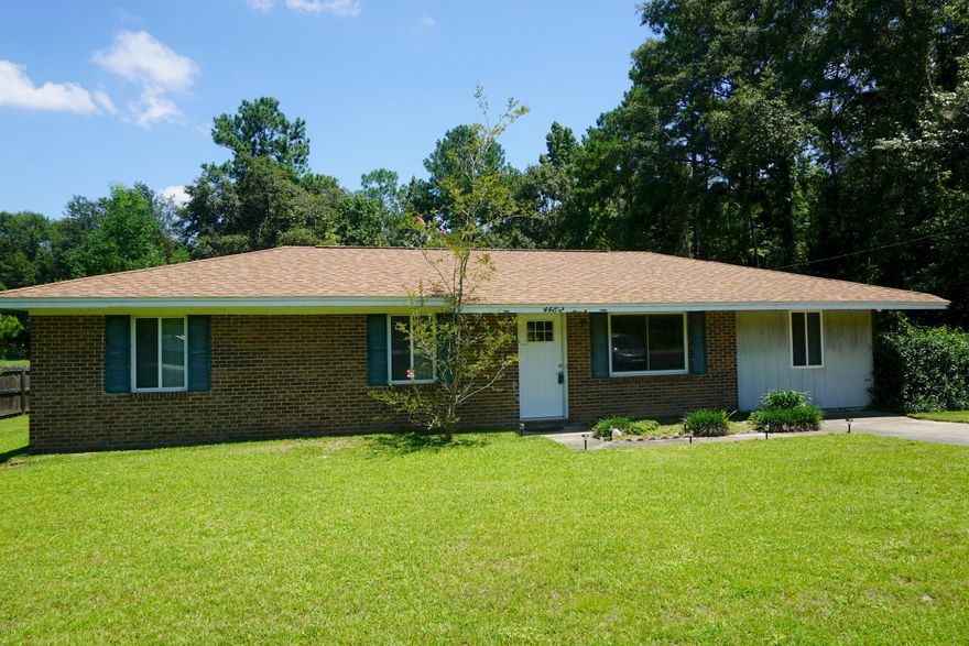 This home has been remodeled and has some beautiful features such as the ceramic tiled flooring, newer kitchen cabinets w/ beautiful backsplash, and large dining area open to the living space. You'll love the updated bathroom w/ bath tub and tiled surround, and contemporary vanity.  This home also has a bonus room that could be made an office, hobby room, or playroom w/ laundry room access and exterior door to the spacious patio.  Create an outdoor oasis in this outdoor living space, screened by greenery & the 16 x 20 workshop. This yard is great for children or pets alike. Home boasts a newer roof replaced only 3-4 years ago.