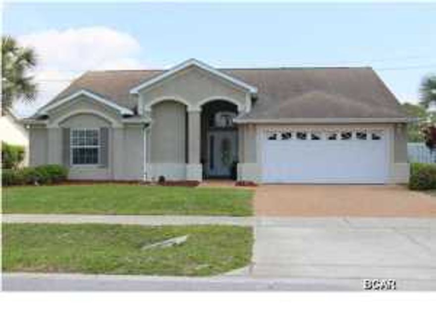 Don't miss your opportunity to own the best priced pool home in Summerwood! This beautiful 4 bedroom, 2.5 bath home has tiled flooring throughout the main areas. The living room has high ceilings and is open to the kitchen. The kitchen features a breakfast bar, solid surface countertops, and white appliances. The master bedroom has his and hers walk in closets and overlooks the GORGEOUS inground swimming pool. Master bath has a double vanity, tub/shower combo, and a water closet. This a split bedroom floorplan with 3 bedrooms that share a full bath and a 1/2 bath. There is a huge inground swimming pool with a waterfall, pavered deck, and a pirate themed pool house! This neighborhood is located close to Pier Park and the world's most beautiful beaches. Schedule your viewing today!!!