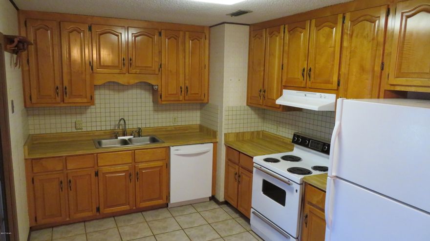 Well kept 3 or 4 bedroom BRICK home in an established neighborhood near Tyndall. This home has a kitchen with oak cabinets, all appliances, tile floor and a spacious dining area. The living room is carpeted & the 16x24 den has tile flooring and overlooks the back yard. On one side the den is adjoined by a 12x16 sun room and on the other side is a covered deck. The garage was converted into an office/den  with closet and built in shelving and this room could also be used as a 4th bedroom. There is an abundance of built in storage and an 8x11 laundry room. In 2005 the roof was replaced  with architectural shingles. A new water heater was installed in Jan 2017. The HVAC system is approx 7 yrs old. You will like the sturdy storage shed in the privacy fenced yard. Call to view before it's gone!