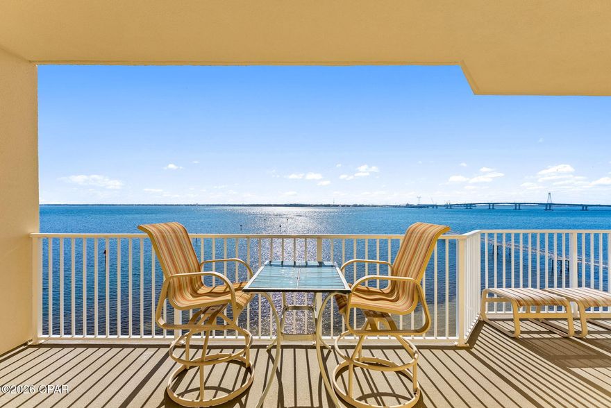 Wake up to breathtaking sunrise views over St. Andrew Bay and the Hathaway Bridge from this beautifully updated 5th-floor waterfront condo. Hurricane-rated sliding glass doors open to a spacious 200 sq ft balcony, creating the perfect indoor-outdoor retreat for morning coffee or evening relaxation. Located in the gated Hibiscus by the Bay community, this home blends coastal views with modern updates and resort-style amenities. Inside, the condo offers a bright and welcoming space with crown molding and updated flooring throughout, creating a clean coastal feel that complements the waterfront setting. The kitchen has been tastefully updated with granite countertops, stainless steel appliances (2021), and brand-new cabinetry, providing both style and functionality for everyday living or entertaining. The primary suite overlooks the bay and features private balcony access along with a beautifully remodeled bathroom complete with a step-in shower, jetted soaking tub, double vanity, and walk-in closet. Additional recent upgrades include a new HVAC system (2023), hot water heater (2023), and washer and dryer (2024), offering peace of mind for years to come. Situated on a private gated 10-acre peninsula with its own marina, Hibiscus by the Bay offers a peaceful bayfront lifestyle without the turnover of short-term rentals. Residents enjoy two swimming pools, tennis and basketball courts, dog walking areas, a fire pit, a 500-foot fishing pier, and a clubhouse. Nearly $7 million in community improvements along with reduced HOA fees have further elevated this sought-after waterfront community. A serene waterfront retreat located just minutes from the world-class beaches, dining, and entertainment of Panama City Beach.