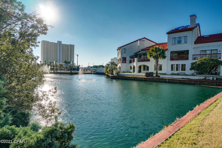 CURRENTLY UNDER CONTRACT, SELLER ACCEPTING BACKUP OFFERS. Welcome to your New 2BR/2BA Beach Condo, overlooking the Lagoon, in the gated, quiet community of Villas of St Thomas, located a block away from the Gulf of Mexico! Enjoy the spectacular views of the Lagoon from both the main living area and Primary Bedroom Suite in this beautifully updated 2 Bedroom, 2 Bathroom unit.  EXTRA Large private Balcony! The open floor plan allows for gorgeous views of the Lagoon in the main living areas, including the kitchen, which features custom updates including Bosch stove/oven, microwave and dishwasher, Kitchen Aid 5 door Refrigerator, and quartz countertops. The Primary Bedroom suite offers gorgeous views of the Lagoon, features a large sitting area, balcony access, and a HUGE walk-in closet. The primary bedroom en suite shower has Upgraded Shower Massage Heads. This Unit has been completely updated with custom lighting and ceiling fans with remotes, all new BOSCH Kitchen appliances and Kitchen aide refrigerator, an Oversize Kenmore Stacked Washer/Dryer, and this unit's HVAC has an Air Scrubber by Aerus with "ActivePure" Technology for air purification. Bring your boat and take advantage of all the community amenities Villas of St Thomas has to offer, including the Community Boat Dock, Community Pool, Tennis Courts, Grilling Area, Firepit and Wonderful Shops in the Walkable Community. Close to Shopping, Entertainment and Restaurants. Short term Vacation Rentals Allowed. Pets Allowed for Owners. St. Thomas Square is a Grand Lagoon waterfront property with a boat dock. Gulf access is about 20 minute boat ride to the pass. All ages, room sizes and measurements are approximate. Call today to see this gorgeous Beach Condo in person!