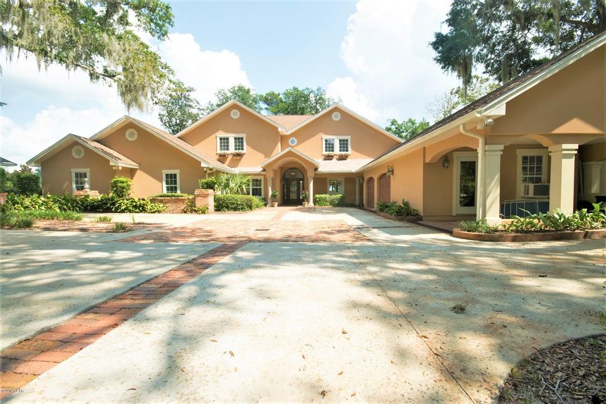 CURRENTLY UNDER CONTRACT, SELLER ACCEPTING BACKUP OFFERS



Welcome to this spectacular property located in the Cove on a bluff overlooking Watson Bayou. As you drive through the gates, you will step into a bit of New Orleans, including a unique brick accented drive. The home underwent a major renovation in 2003, upgraded throughout with today's amenities, adding significant square feet and a second story. The residence offers a formal dining room, chef's kitchen open to a family room and casual dining area, with gorgeous views of the water. The large living room has 10-foot recessed ceilings, beautiful wood burning fireplace, a wall of built-in bookcases, and opens onto a glass walled sun room, again with expansive water views. The first floor includes a large master suite with water views, and three additional bedrooms with ensuite baths.

Upstairs you will find a huge game room, two additional bedrooms and a bath with steam shower.

The terraced backyard opens to an outdoor kitchen, covered patio by the heated pool and hot tub on the upper deck ï¿½ï¿½" all overlooking the open water ï¿½ï¿½" and steps down to the bottom deck and dock, with a boat house, boat lift and sunning deck.

Too many amenities to list!  Come and see!