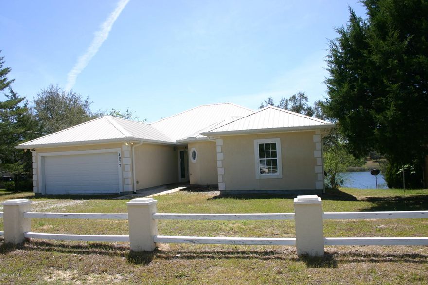 Huge home overlooking Boat Lake in Sunny Hills. This home built in 2009 features all steel beam framing, stucco exterior, and a metal roof. Also has a full walkout basement that is unfinished and just waiting to be made into a large game room, or can be converted to 2 additional bedrooms and a full bath. (framing was started to do this.) Upstairs you will find 3 bedrooms and 3 bathrooms. Designed as two master suites with both bathrooms having Jacuzzi tubs and showers. The owners bedroom has an awesome view of the water. The kitchen is very spacious and has refrigerator, dishwasher, stove, and microwave. Large laundry room and pantry convenient to the kitchen. Ceramic tile floors throughout entire house. From the living room there is a gas fireplace and access  to a deck overlooking water. Total under roof including the unfinished basement is 4533 square foot.