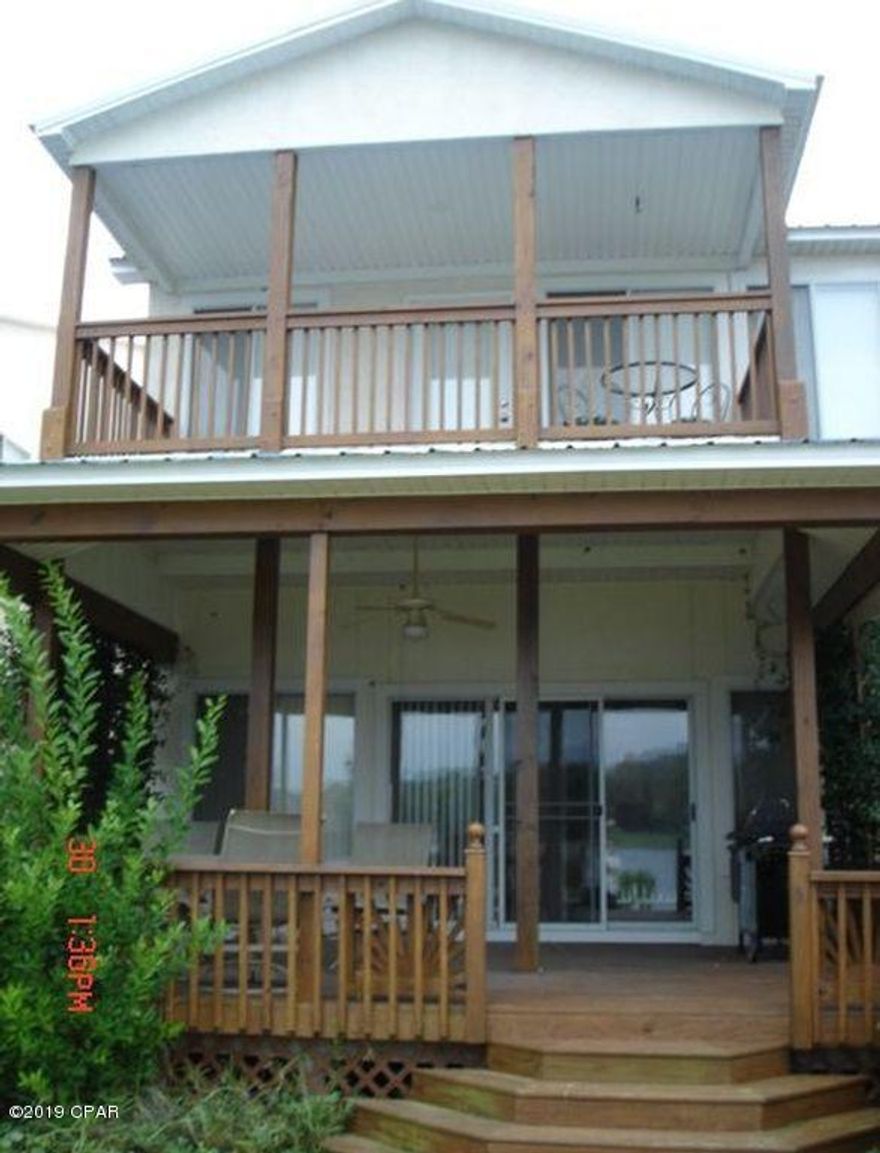 This beautiful, waterfront property has 180 degree water views. Newly remodeled with an open floor plan concept through out the main floor which includes a newly updated luxury kitchen with new stainless steal appliances. New floors through out home. An extra large covered rear deck is perfect for sunset watching over the bay. Upstairs a private balcony off the master bedroom adds a permanent vacation feel to the home. Master also includes an exclusive full bath with walk in shower and large garden tub. Two additional bedrooms with full bath is perfect for families or guests. Property includes a 2 car garage, in ground sprinkler system and exclusive access to a 150 foot dock with a personal boat slip designated to this unit for personal use.