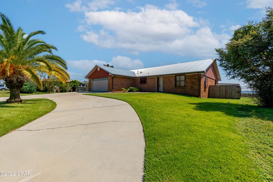 WATERFRONT close to Tyndall Air Force Base. Beautiful home with an amazing view. Interior features of this home include tile floors, updated kitchen with quartz countertops, split floor plan bedrooms, and a large screened in porch just off of the living room.Exterior features of the home include a new sea wall, hurricane shutters over every door & window of the home, storage building, deck, and irrigation system for the yard. Home also has 2 new roofs. Sellers had the shingle roof replaced after hurricane Michael and have since installed a new metal roof over it. The Gulf is accessible by smaller crafts from the canal behind the house.