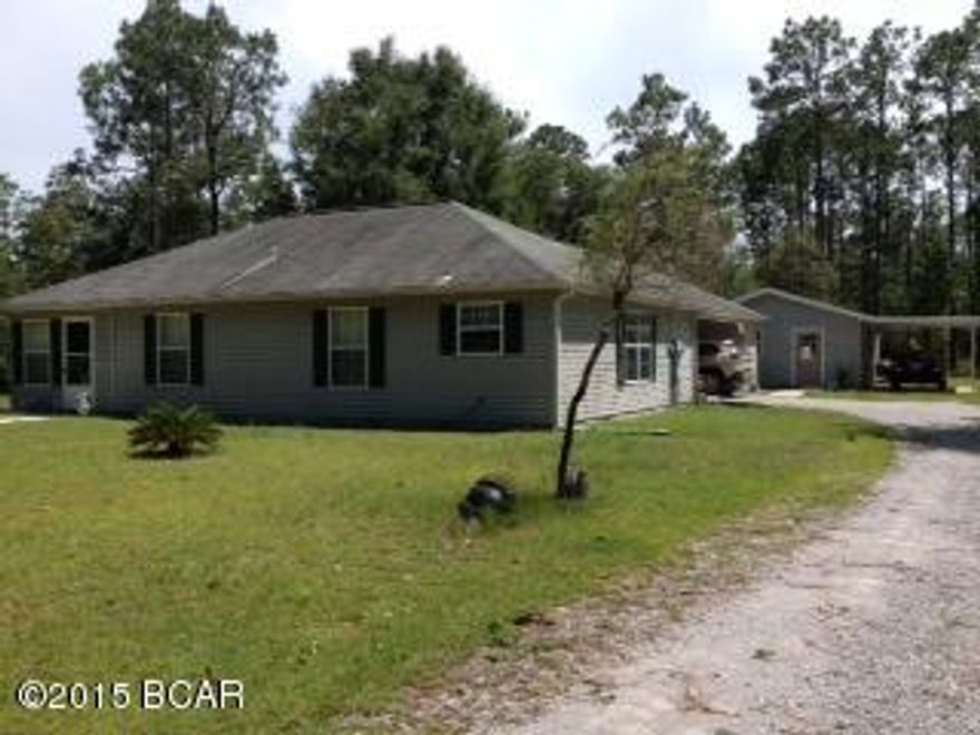 The pool is open at the pavillion! In the gated community of Leisure Lakes, this 3 bedroom, 2 bath house with no steps is waiting for you. Situated at the end of a cul-de-sac on 3.25 acres, it offers quiet living with a carport, storage room and a 20x20 workshop. The eat-in kitchen has plenty of counter space and a pantry. The utility room is just off the kitchen and offers more storage. The large master bedroom has a walk-in closet, and the bathroom has a large shower. The second bathroom is between the other 2 bedrooms. The living room has a fireplace, and the flooring is laminate but carpet in the 3 bedrooms. The subdivision offers recreation including two lakes, two boat ramps, fishing swimming, pool, kitchen rental at the pavillion, exercise room, tennis and basketball courts.