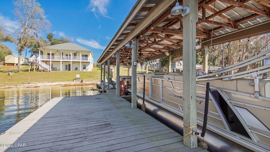 UNDERCONTRACT!!!TAKING BACK UPS. COMPASS LAKE!!!  What a Gem, this home is on two lots with two wells and some of the best sunsets around.  Upstairs there are two bedrooms, two baths, living, kitchen and dining with a back porch to the lake that is 45 feet long with views to enjoy. Downstairs there is a bath, large laundry/storage area, open gathering room and another room you could use for sleeping.  Outside is an outdoor shower, a huge dock , with electric boat lift, steps into the water, electricity and water running to the dock.  The most relaxing place on the planet is on that dock with your feet dangling in the water.  There is a large beach area for swimming and relaxing in the sun.  This is a MUST SEE!!