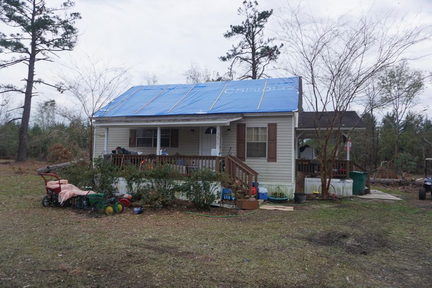 Investment Opportunity! This property features a 2 bedroom 1 bathroom cottage on 1 acre of land. It has two spacious living rooms, and a bonus room upstairs. The home has a front and side covered porch and small storage building in the yard with lean-to. It was damaged by Hurricane Michael and is being sold as-is. It has a damaged roof and some interior repairs that would need to be done as a result from the leaking roof. It has been used as a rental for over 10 years and most recent rental rate was $750 per month.