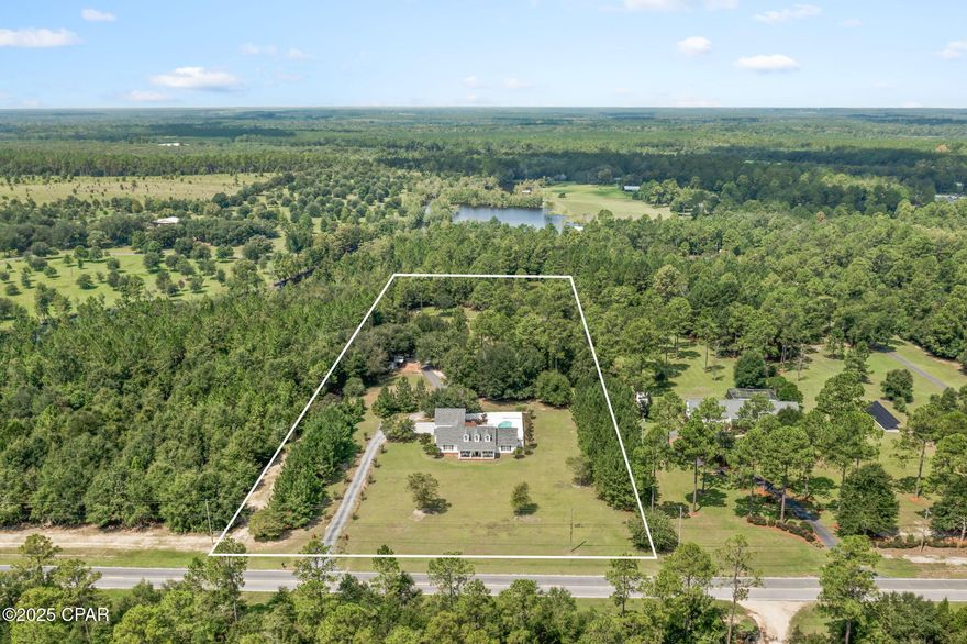 Located on the highly desirable Piney Grove Road, this beautiful 4-bedroom, 2.5-bath home offers the perfect blend of comfort, charm, and outdoor living. Step inside to an inviting open living, dining, and kitchen area where the living room features a striking shiplap accent wall, hardwood floors, and a cathedral ceiling. The kitchen is a true centerpiece with granite countertops, stainless steel appliances, pantry, and a breakfast bar for casual dining. The master suite is thoughtfully placed on one side of the home and boasts his-and-hers walk-in closets, a double vanity, and a custom tiled shower. Two guest bedrooms share a convenient Jack-and-Jill bathroom, while the fourth bedroom offers flexibility for family or guests. Outdoor living is at its best with a covered patio, open deck, sparkling in-ground swimming pool, hot tub and a convenient outdoor shower, perfect for rinsing off after a swim or a day spent outside. A 2-car garage provides ample storage, while the property also features an enclosed barn equipped with a bar, built-in bunks, and a full bath, an ideal space for hosting game nights or out-of-town visitors. Enjoy peaceful views with private access to a picturesque pond complete with a swing, an inviting spot to sit back and unwind. This Piney Grove gem truly has it all, indoor style, outdoor fun, and a location you'll love!