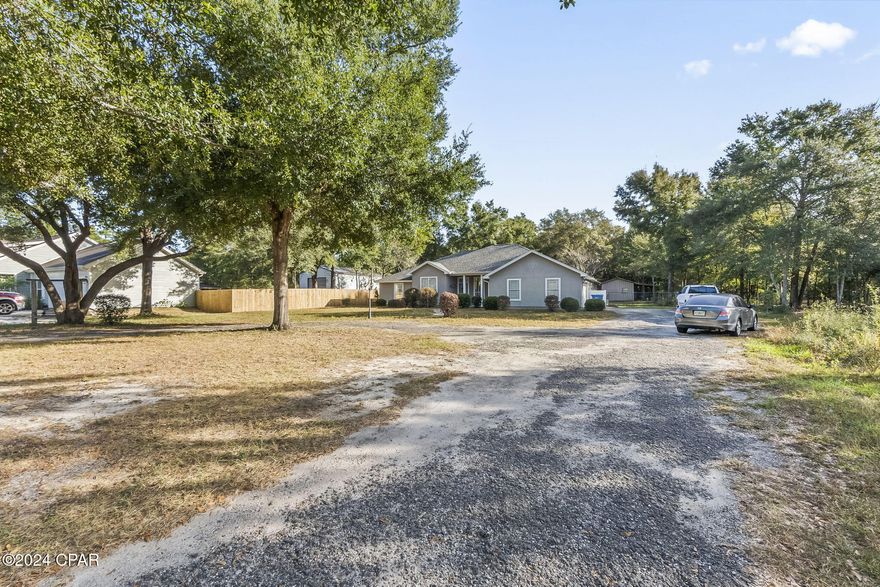 All sizes taken from tax records///Custom built home situated on .97 Acre lot///large workshop/storage shed situated around Oak trees, orange tree, and Lots of Shade!  Fenced back yard with motor home electrical hook-ups--outside shower!!! Price right for quick sale--owner moving!! ////Near new airport, Panama City Beach (30 Min) Southport, and Lynn Haven--zoned for Bozeman school (kindergarten-thru High school)///  Home has 3 bedroom's -2.5 baths--with study that easy could be used as 4th Bedroom//--Jack and Jill Bathroom between the two bedrooms --great for children and quest///Great neighborhood to raise your famil---convenient to everything?  Country living at its best!!!!